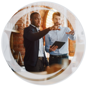 Eastern Savings Bank Business Banking. Two business men standing in restaurant discussing layout plans