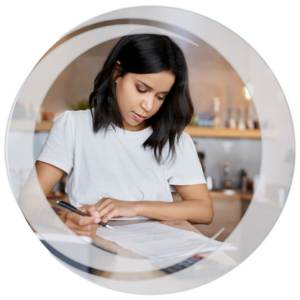 Eastern Savings Bank Business Banking. Business woman sitting at table reviewing document