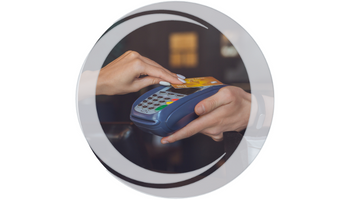 Debit card. Hand with debit card hovering over contactless payment terminal