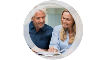 Savings Accounts. Husband and Wife sitting reviewing savings account statements